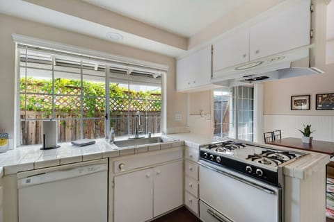 Spacious kitchen featuring natural lighting and outdoor views.