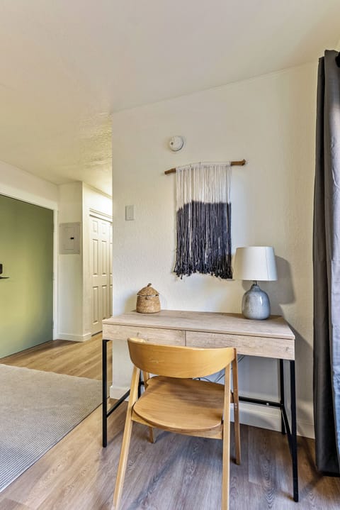 A cozy and modern entryway with a minimalist desk setup, decorative wall hanging, and soft lighting — perfect for remote work.