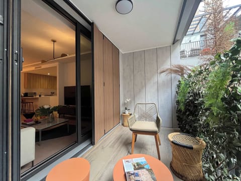 Balcony/patio with plants and seating.