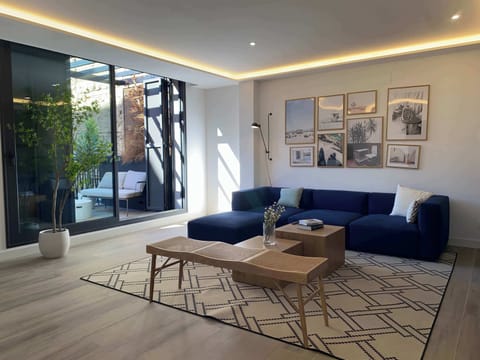 Living room with blue sofa and artwork.