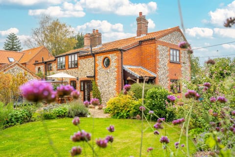 Annie's Cottage, Sharrington: A three bedroom brick and flint cottage with a stunning garden and open countryside views from the front