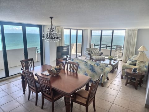 Large living area with oceanfront balcony access. 