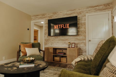 Cozy living room with plush seating, smart TV, and warm lighting for relaxing.