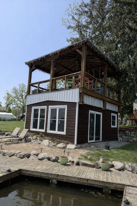 Lakefront exterior with elevated deck and private shoreline access