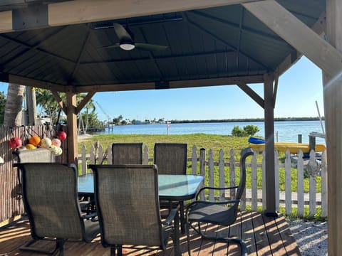 Outdoor Gazebo with Television, Ceiling fan and ring toss game.