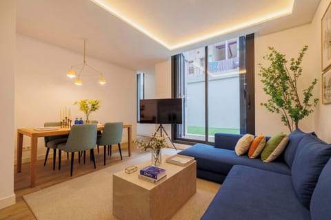 Dining and living area with blue sofa.