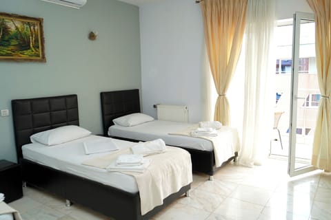Family Quadruple Room, City View | In-room safe, desk, laptop workspace, soundproofing