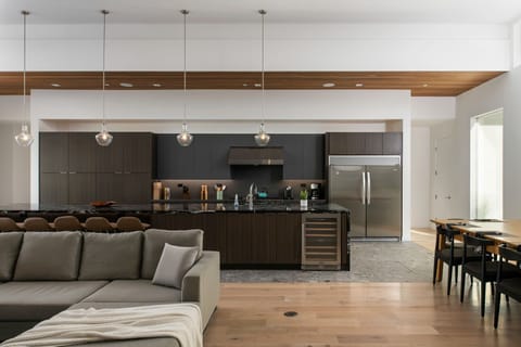 The expansive chef's kitchen and dining area, featuring a massive marble island, professional appliances, and plenty of seating for your entire group.