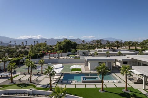 Incredible aerial views of the entire Elemento 49 resort compound, showcasing the pool, spa, Pickleball court, putting green, and the majestic mountain panorama.