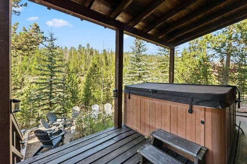 Soak in your private hot tub at 279 Shorewood Drive while enjoying sweeping forest views from this covered terrace.