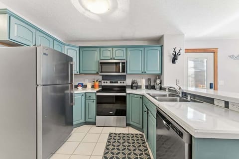 Your charming teal kitchen awaits with modern appliances and all the essentials for creating delicious meals during your stay.