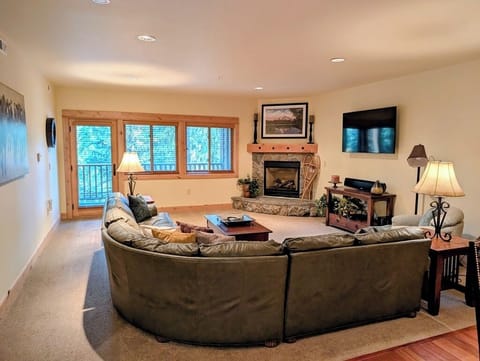 Spacious living room with views looking out over Collins Lake