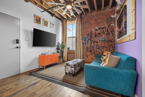 Cozy sofa bed surrounded by Nashville-inspired art and exposed brick.