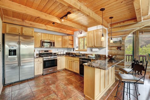 well-appointed kitchen with stainless appliances and plenty of supplies for cooking cozy meals at home