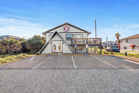From the street, this home presents a striking front elevation with a raised design that maximizes views and privacy.