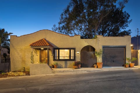 A stunning twilight welcome awaits. Step into old-world Spanish charm updated with modern style.