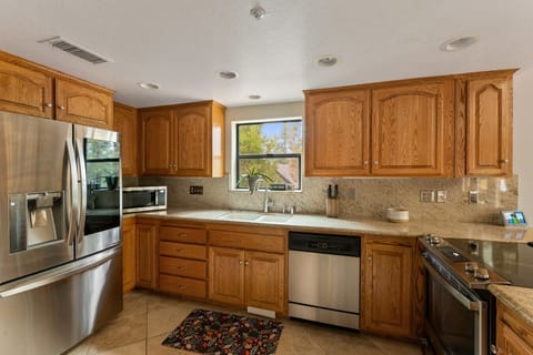 Warm kitchen with full size appliances including a dishwasher