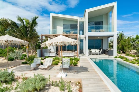Arrive to a sleek beachfront villa with a dazzling pool.