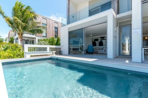 Slip into sparkling waters steps from your sunlit living space.