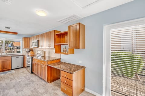 Fully stocked kitchen with cookware, Keurig coffee maker, and open layout at Florida Keys rental.