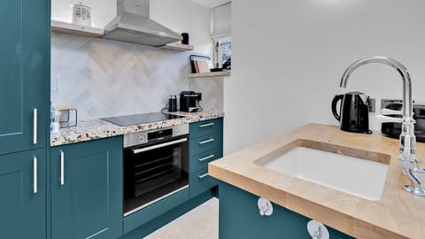 This stylish room is made for cooking meals together with an oven and hob, kettle and toaster, fridge/freezer and a coffee machine.