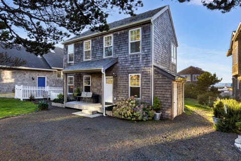 Enjoy the beautiful exterior and inviting front porch of this classic beach home, perfectly nestled on the coast.