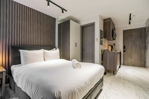 Cozy bedroom featuring a comfortable bed and wardrobe