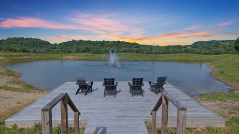 Backyard: Escape to tranquility! Enjoy the beauty of your own lake on our expansive 15-acre estate.