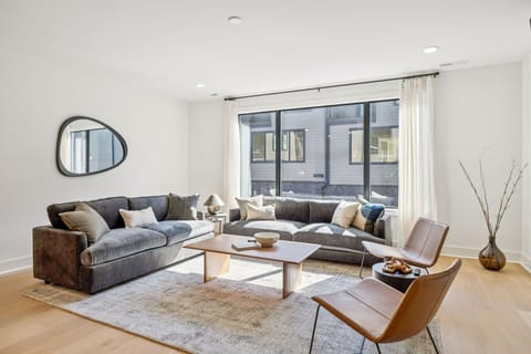 Living Room: Where modern design meets cozy comfort — unwind with friends and family in this elegant, sun-filled living room.