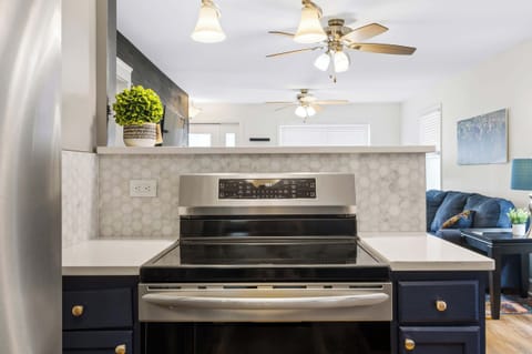 Kitchen: Cook and Connect – Enjoy this inviting kitchen with bold blue cabinetry, sleek finishes, and cozy seating that makes mealtime a delight.