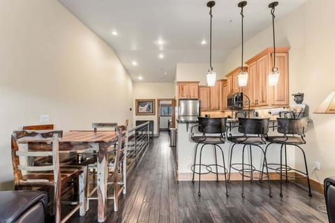 Gather around your spacious open-concept kitchen featuring warm wood cabinetry, granite countertops, and a breakfast bar perfect for morning coffee chats.