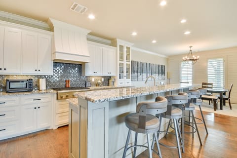 Gourmet kitchen with stainless steel appliances and breakfast bar.