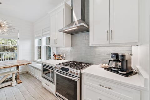 Beautiful kitchen featuring a large island, stainless steel appliances, ample seating, and fully stocked with all your essentials.