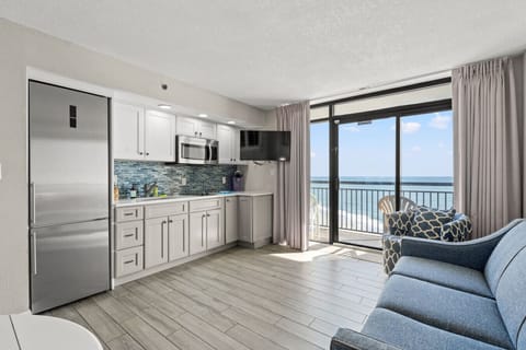 Oceanfront living room designed for relaxation after a day in North Myrtle Beach. Sink into the comfy sofa, admire endless sea views, or step onto the balcony overlooking the waves and pools. Includes a queen sleeper sofa for added space and comfort.