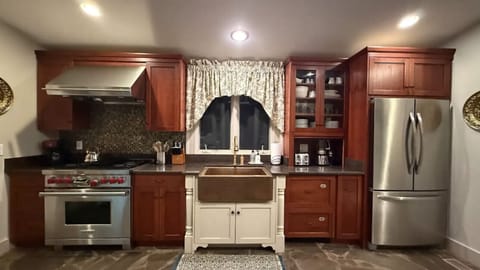 Fully equipped kitchen featuring cookware, appliances, and dining essentials
