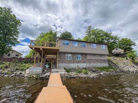 Waterfront home with private dock and spacious deck views