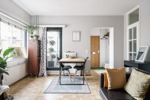 The dining area doubles as a comfortable workspace with plenty of natural light and direct access to the balcony for fresh air.