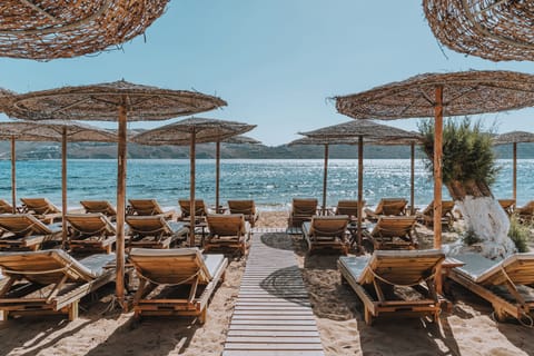 On the beach, white sand, sun loungers, beach umbrellas
