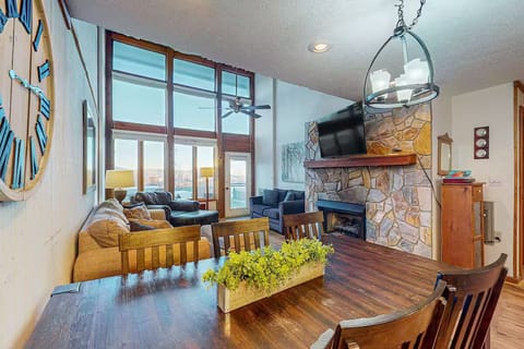 Breathtaking great room with fireplace and floor-to-ceiling mountain views.