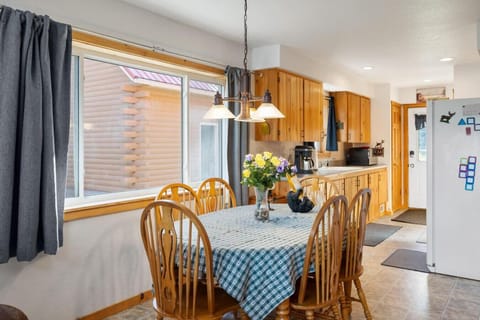 Dining Area | Bright Space with Forest Views and Rustic Wood Furniture