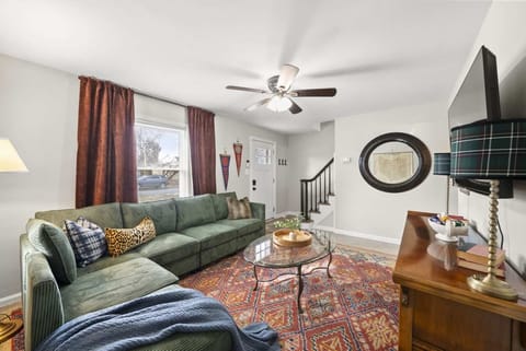 Cozy living room w/ plush sofa, layered rugs & warm decor that invites you to kick back & relax.