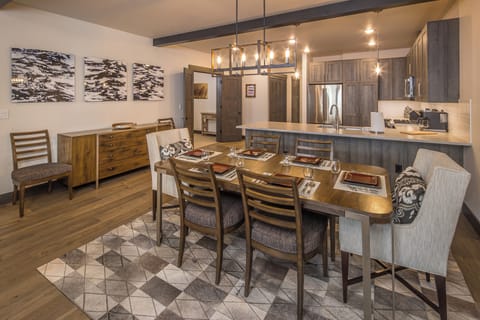 An open-concept dining area featuring wood accents, modern lighting, and a spacious layout perfect for gathering and entertaining. | Main level