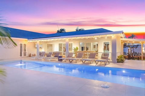 As the sun dips below the horizon, the pool area glows under string lights and pastel skies — the perfect setting for a refreshing swim or a quiet evening unwind. ????✨
