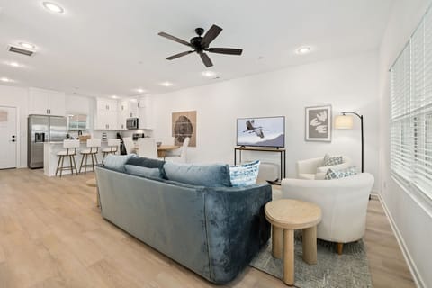 The living room features a large Smart TV with all your favorite streaming channels, along with plush seating. 