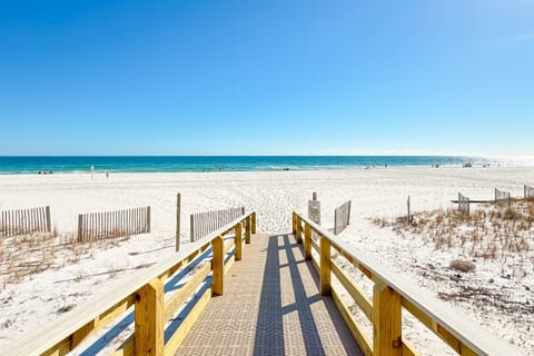 Directly on the sands, this beachfront building offers unparalleled access to the shore and stunning coastal views.