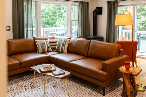 Cozy and inviting! The main living room has a comfy couch and smart TV, plus a relaxing gas fireplace seating area—just flip the switch and unwind. Perfect for movie nights or morning coffe