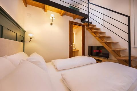 Deluxe Triple Room, Mountain View | Minibar, in-room safe, blackout drapes, free WiFi