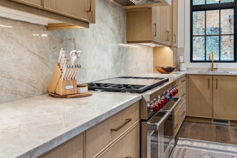 A huge chef's kitchen is well stocked with premium appliances and supplies, two kitchen islands, a built in dining area with beautiful alpine views.