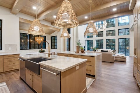 A huge chef's kitchen is well stocked with premium appliances and supplies, two kitchen islands, a built in dining area with beautiful alpine views.