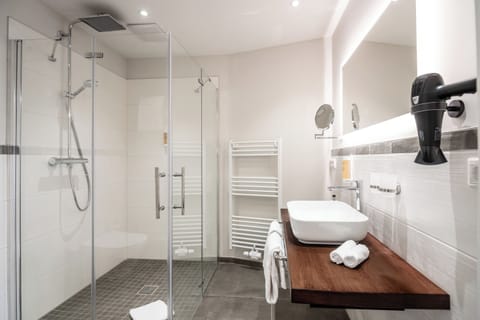 Shower, rainfall showerhead, hair dryer, towels